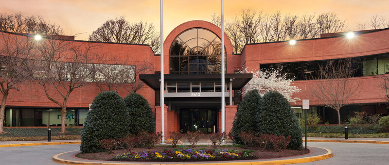 Virginia Cancer Specialists office exterior at dusk