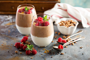 Healthy chocolate and yogurt layered dessert with raspberry