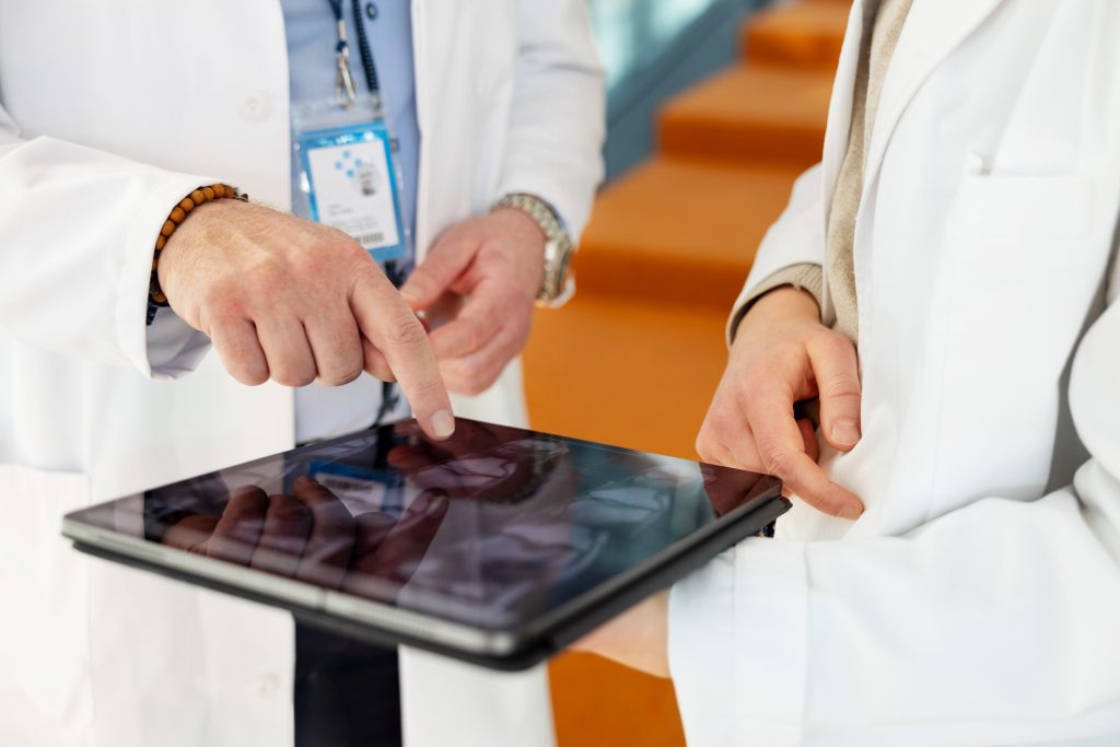 Oncology team reviewing medical imaging on a tablet.