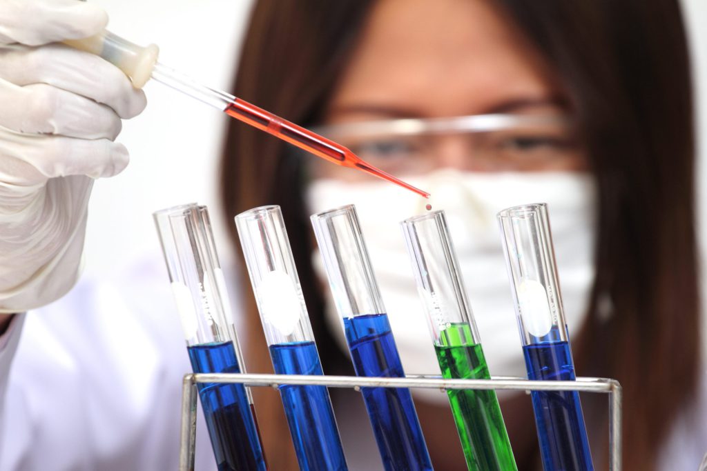 Scientist Or Tech Holds Liquid Biological Sample In Gloved Hands