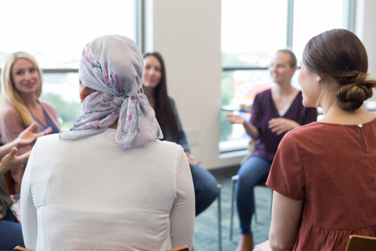 Patients participating in a cancer support group conversation.