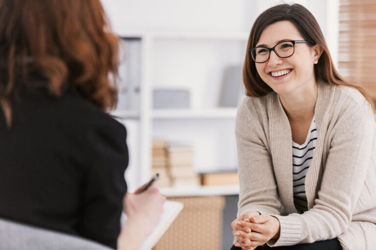 Patient speaking with a genetic counselor during a supportive consultation.