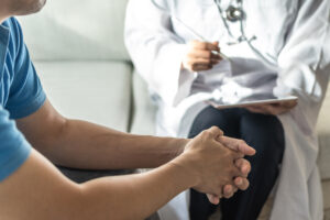 Men health disease or mental illness concept with male patient having consultation with doctor or psychiatrist working on diagnostic examination in...