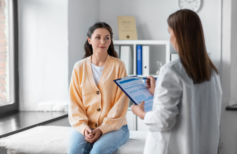 Physician reviewing information with a patient in a hospital setting.