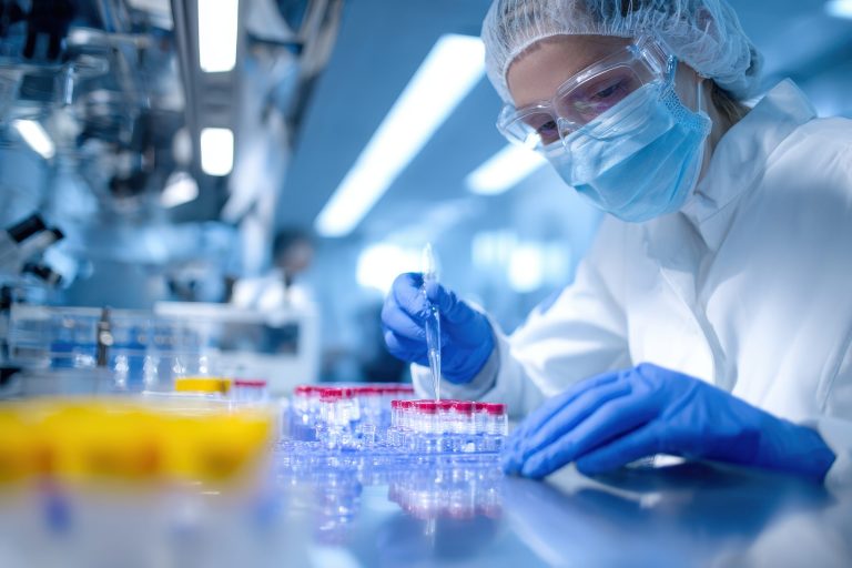 Radiopharmacist working in a laboratory preparing radiopharmaceuticals for research and clinical applications with precision and safety measures in place